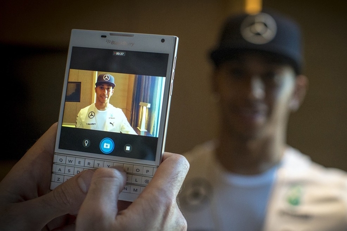 F1 driver Lewis Hamilton poses for photo taken with a white BlackBerry Passport at the handset’s Dubai launch. F1’s Rosberg, Hamilton launch white Blackberry Passport in Dubai
