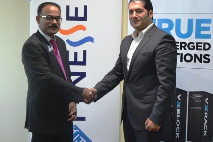 Finesse co-founder and COO Sunil Paul (left), shakes hands with VCE's Said Akar after signing the partnership deal. Finesse partners with VCE