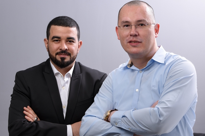 AOC's Sameh Gamal (left), poses for a photo with Sergey Didenko, managing director at SDC after signing the deal. SDC to distribute AGON and AOC monitors in GCC