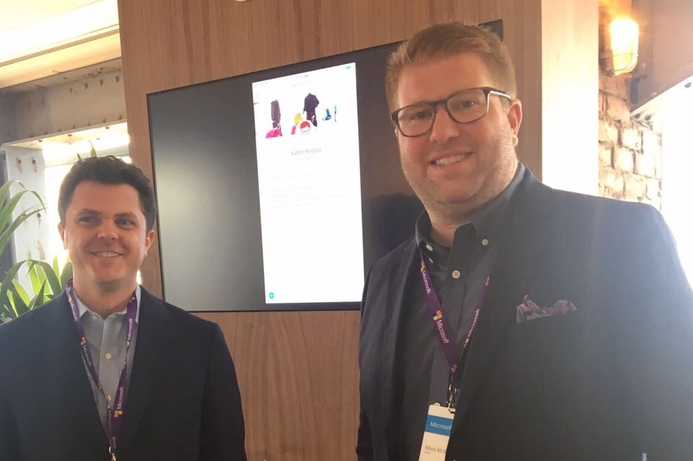 Mark McSpadden (right) demosntrating Sabre AI agency chatbot at a Microsoft event. Sabre adopts Microsoft’s intelligent language services to create AI chatbot