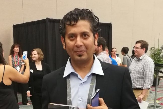 Faisal Al Shamsi with the award from Esri. Sharjah Labour Standards Development Authority wins Esri award