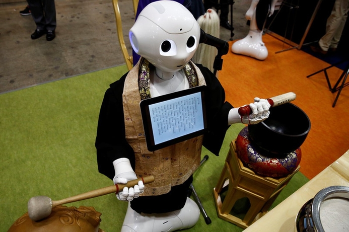 The robo-priest only costs a fifth the going rate for a human priest. (photo courtesy of Reuters) Robot priest available for hire for funerals in Japan