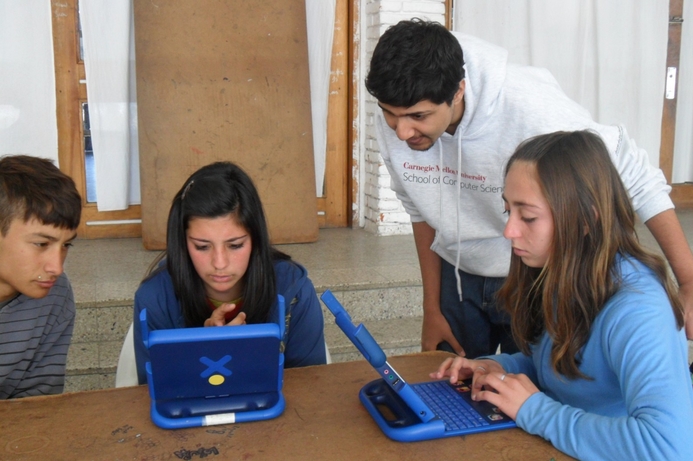 Afnan Fahim with students testing the literacy tools on XO One-Laptop-Per-Child devices. Carnegie Mellon Qatar students work on literacy project for Uruguay