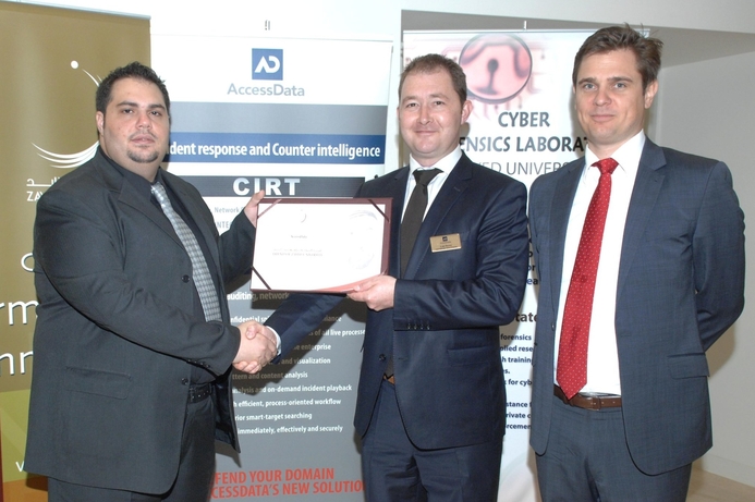Dr. Ibrahim Baggili from Zayed University (l) presenting the ‘Friend of Zayed University’ certificate to AccessData executives Luke Brown and Geoff Brooks. Zayed University and AccessData collaborate on IT forensics