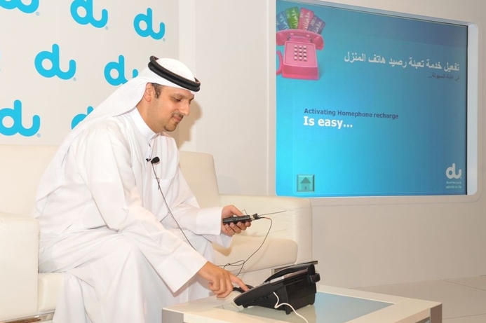 Du's chief commercial officer demonstrates the new Homephone Recharge service at a press conference. Du debuts prepaid landline service in UAE
