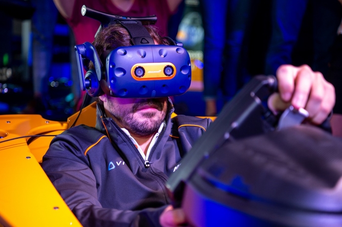 Fernando Alonso with the new HTC Vive McLaren headset. HTC VIVE and McLaren release new VR headset