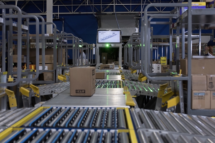 The FAST Unloader works in store warehouse space to unload deliveries and sort them. Walmart plans to add over 4,000 robot workers